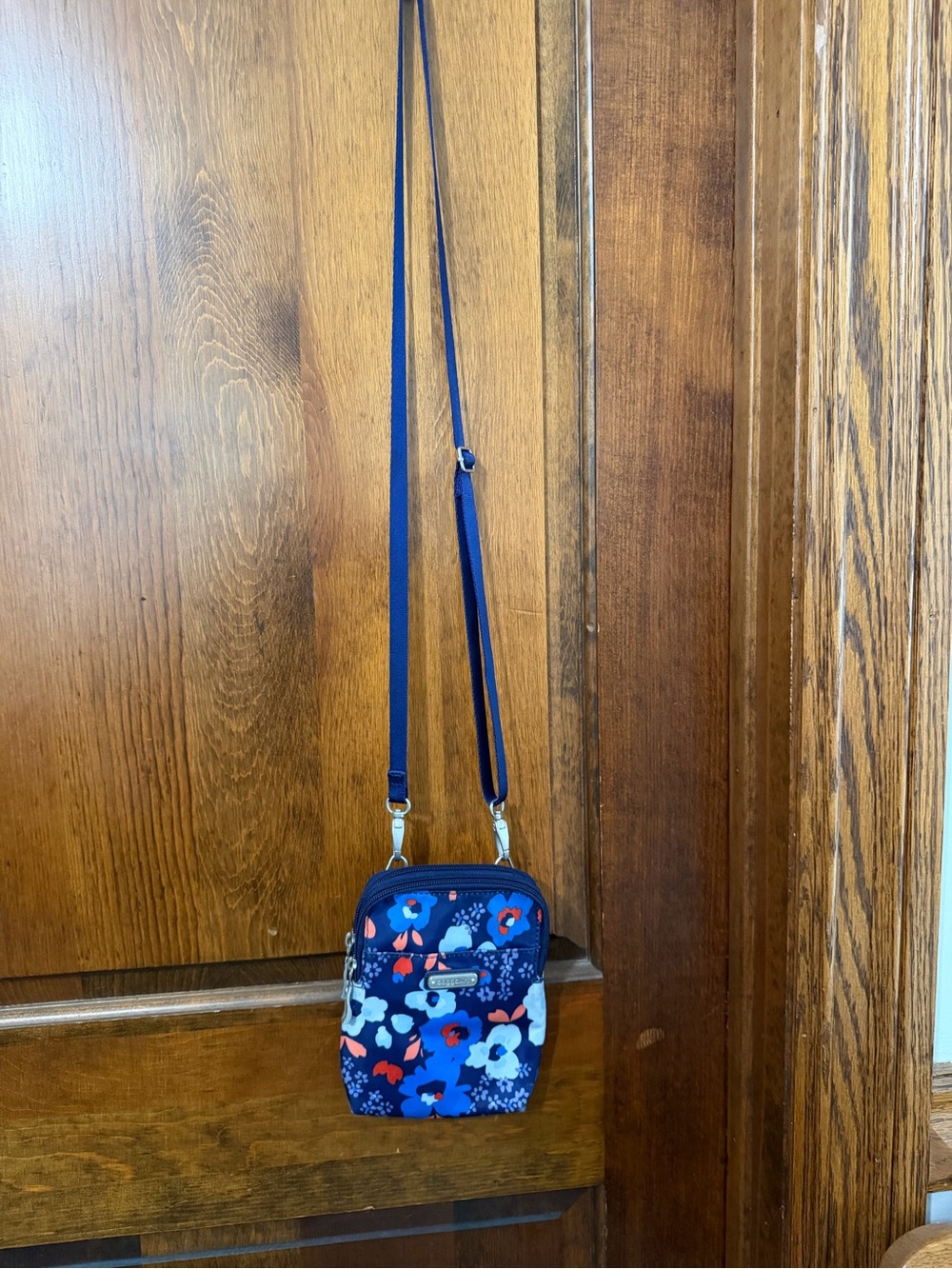 Baggallini Bryant Pouch Crossbody Bag vibrant navy blue and orange floral print